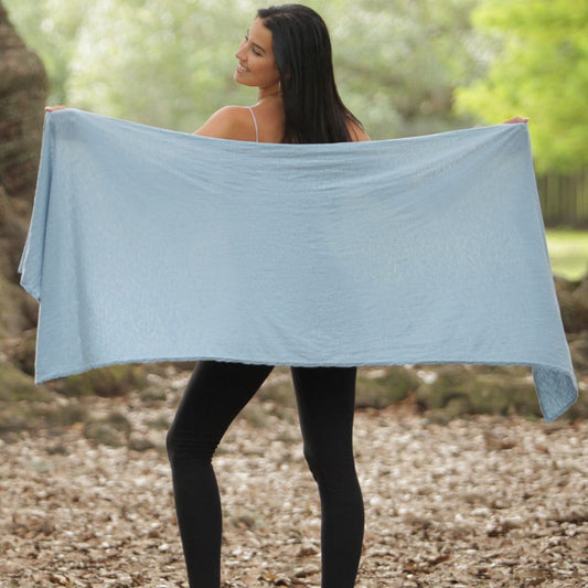 woman holding up Essential Wrap with Insect Shield Repellent