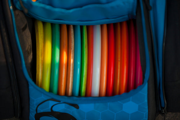Colorful discs in a disc golf bag